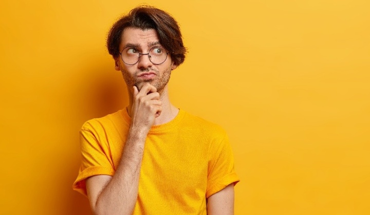 studio-shot-of-thoughtful-man-holds-chin-and-looks-2022-02-06-07-37-31-utc-1-1-1