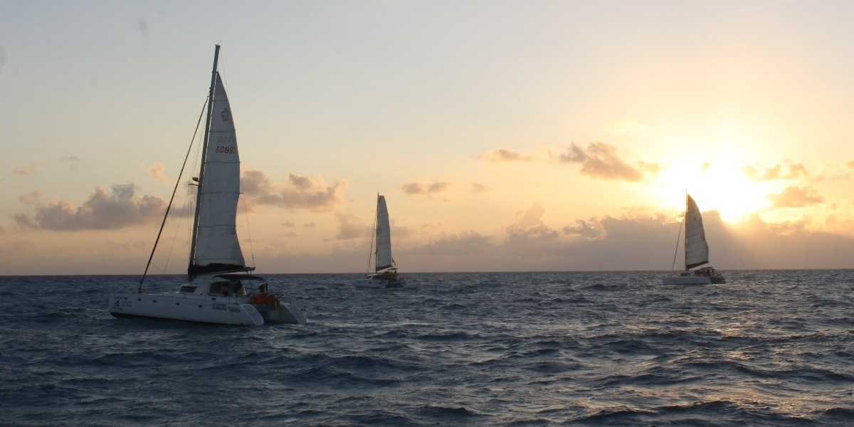 Cancun Sailing catamarans at sunset