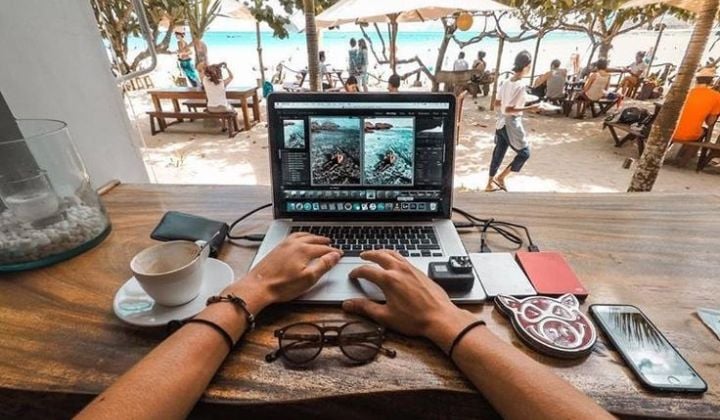hombre trabajando en su laptop con vista al mar